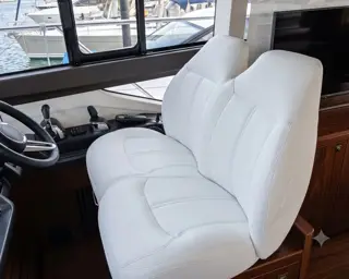 Reupholstered boat helm seat in white marine vinyl